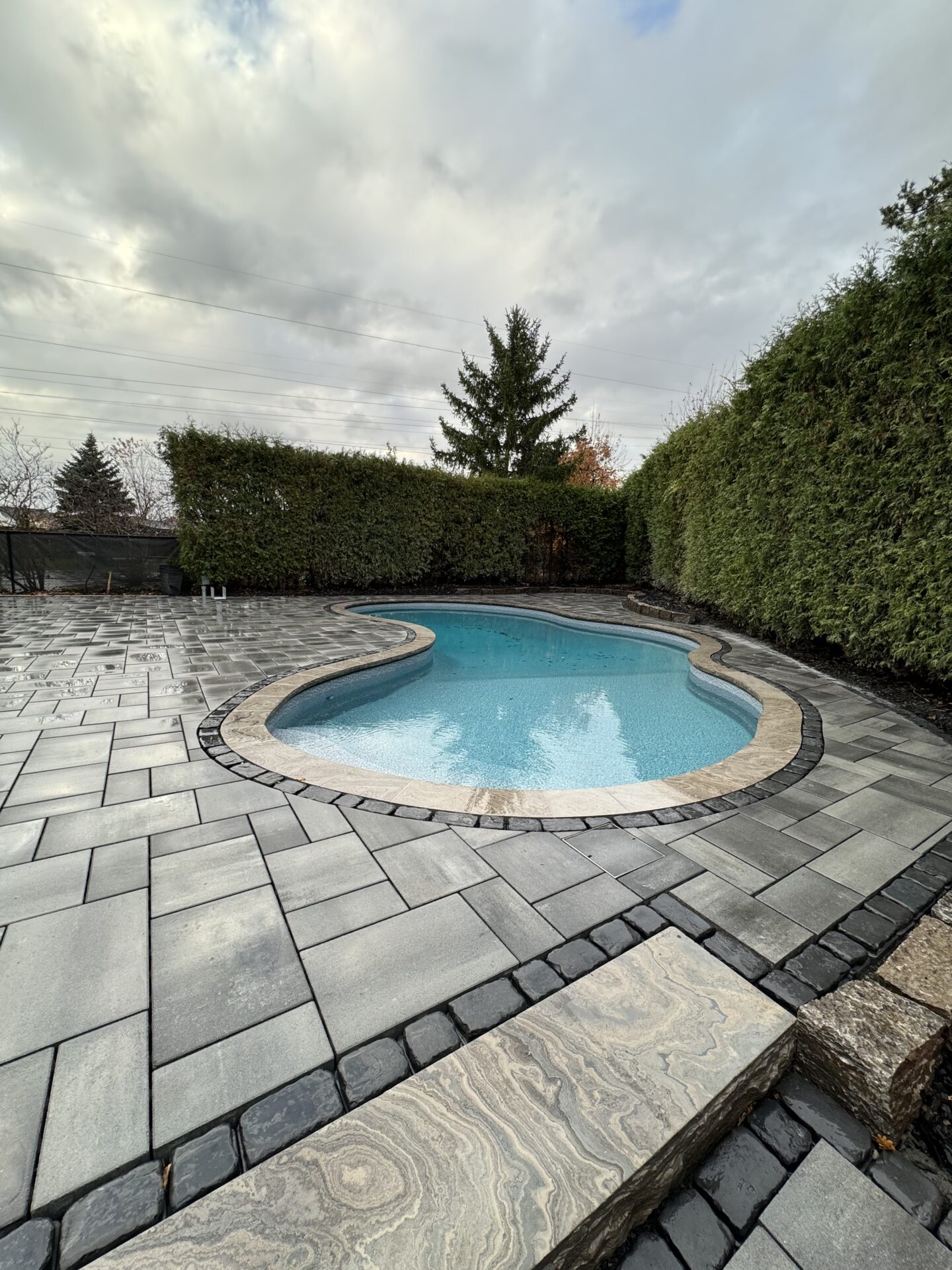 A freeform pool with custom stonework around it.