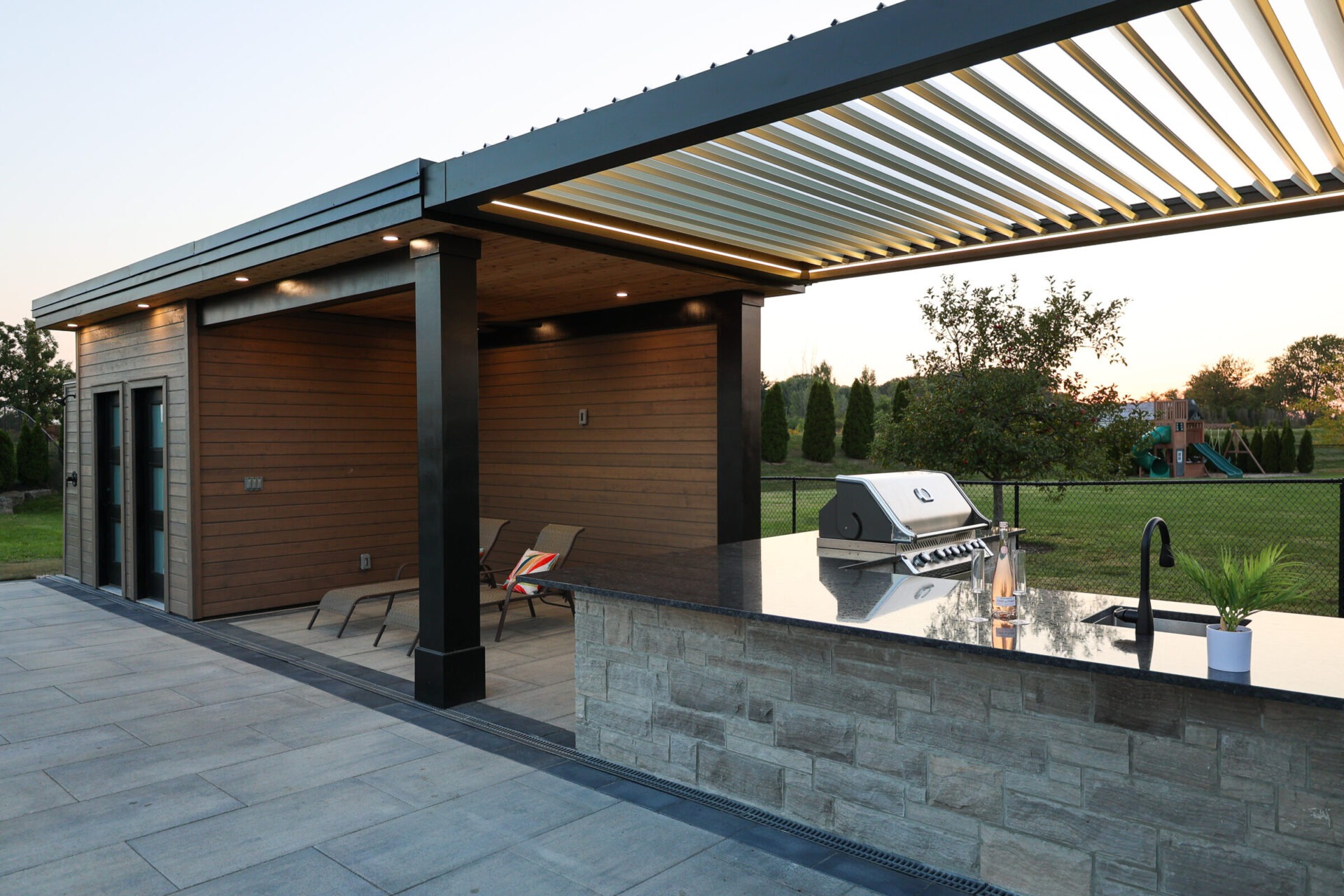Pool cabana and pergola with outdoor kitchen.